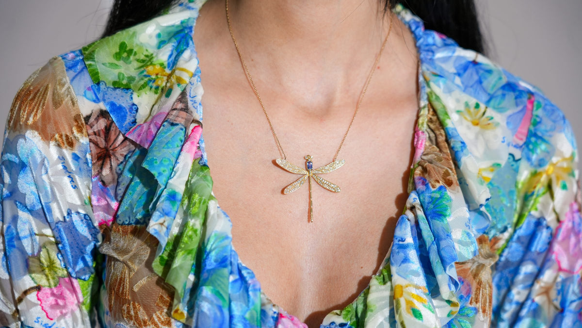 Dragonfly Necklace in 18K yellow gold worn with a colourful floral top